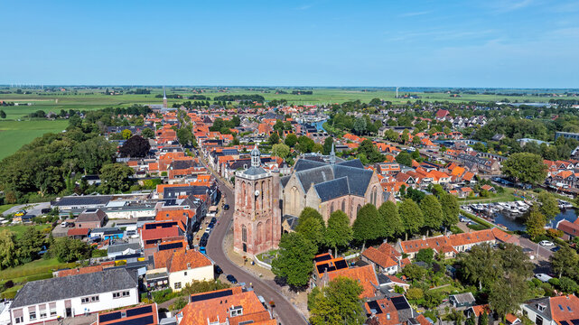 Aerial from the historical town Workum with the St. Gertrudis church in Friesland the Netherlands - Powered by Adobe