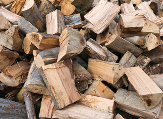 Close-up view of a pile of large chopped firewood logs