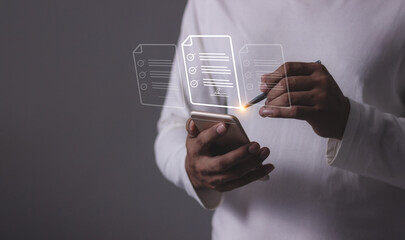 Young man with smartphone mobile hand using a pen touching to sign a Online Business Contract, Electronic signature, Contract signing, Digital documents, Future smart contract