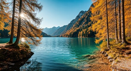 Scenic mountain lake with vibrant autumn trees in the foreground and towering peaks