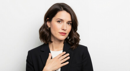 Sincere professional woman with hand on her chest making a heartfelt promise. Grateful businesswoman showing honesty and loyalty. Isolated portrait on a white background with copy space