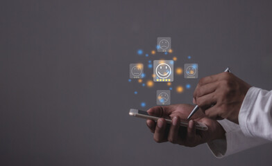 Consumer Satisfaction, Young Man hand holding Smart Phone with five star to review and give 5 stars with very good results in service, Good review 5 star rating choice feedback