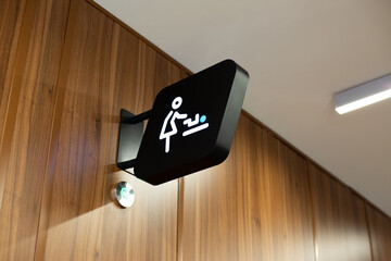 Modern public space interior designates location of diaper changing room for child. Universal sign...