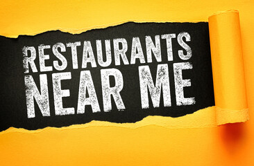 Restaurants Near Me message shown on torn background. Concept for finding dining places, eating...