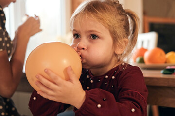 Family Fun Children Joyfully Blowing Up Balloons. Kids inflating balloons, prepare for birthday...