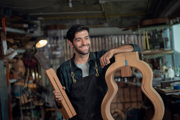Luthier making guitar using traditional tools in workroom with manual tools
