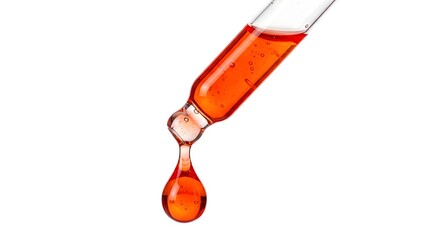 Close up shot of a dropper with a vibrant orange liquid against white background