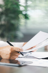 Finance bank tax expense accounting budget money businessman hand use calculator Financial calculate accountant close up calculator with graph chart write office desk Business expense analysis saving