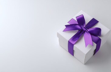 Elegant white gift box with a vibrant purple satin ribbon bow on a plain