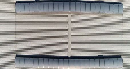  Industrial factory building. Industrial Construction. Polycarbonate Skylight Panels for commercial and industrial building. Warehouse Skylight Roofing. Industrial Metal Roof.Outdoors. Aerial. Over - Powered by Adobe