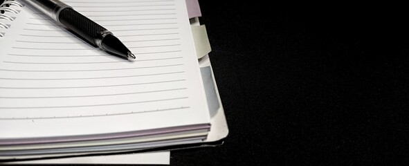 Black pen on lined notebook