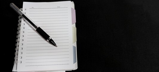 Black pen on lined notebook