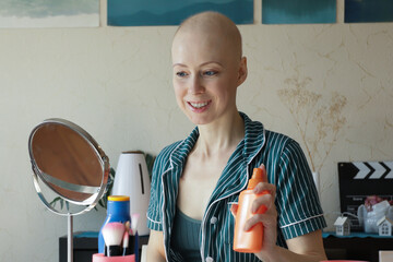 Cancer survivor using sunscreen for sensitive skin, morning beauty ritual at home, concept of health awareness and sun protection after chemotherapy.