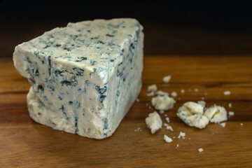 blue cheese on a wooden cutting board close up shallow depth of field