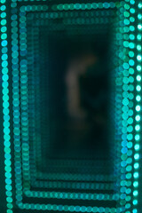 Abstract background of a turquoise bokeh light tunnel.
