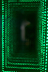 Abstract background of a green bokeh light tunnel.