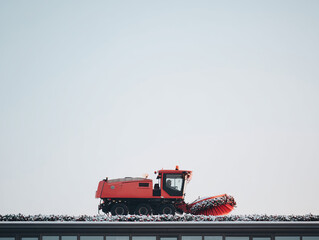 Red snow sweeper snow brush rooftop maintenance snow removal winter equipment vehicle