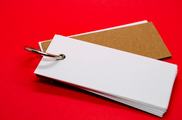 White banner shape notepad with customizable space for text on red cover background.