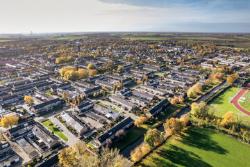 Overview of a suburban neighborhood showcasing residential areas and lush greenery during autumn in the countryside