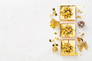 Golden gift boxes and decor on concrete background, top view