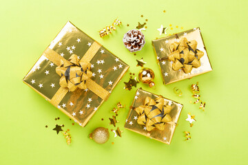 Golden gift boxes and decor on color background, top view