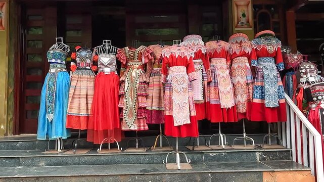Sapa, Vietnam - October 1, 2024: Traditional clothing displayed in front of a shop in Sapa, Vietnam, showcases colorful ethnic patterns and detailed embroidery.