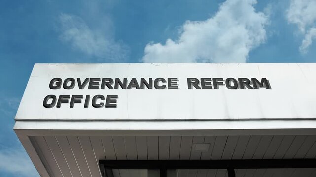 Governance Reform Office word sign clearly displayed on the official government building facade beneath a clear blue sky, signifying the agency or department dedicated to modernizing and improving