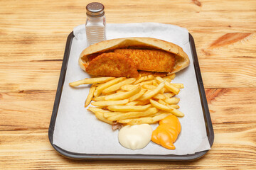 Sandwich cordon bleu sur un plateau avec frites et sauces – restauration rapide turque halal
