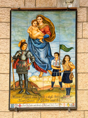 Nazareth, Israel, 5 May 2025. Italian ceramic tile mural of madonna with a knight and catholic scouts