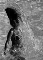 woman shaking her hair in the water