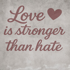 Inspirational quote love is stronger than hate on a textured background