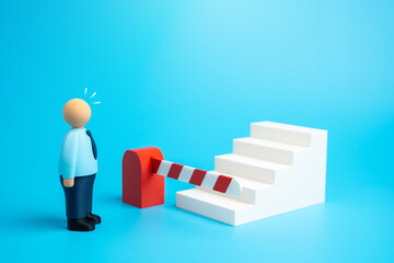 A barrier blocks the office worker's path to advancement. They lack the skills and experience to advance to a higher position. Limited career growth, lack of qualifications, and management barriers.