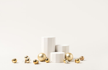 Christmas product presentation scene made with white columns podiums and gold baubles - elegant festive mockup for product, gift, and holiday display.