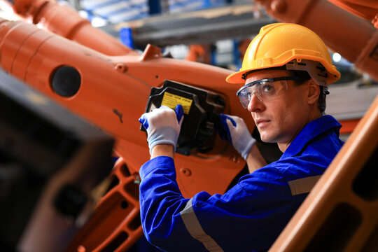 Development technician engineer testing artificial intelligence robot arm at high technology research manufacture with equipment. Factory worker, Electrical engineers working with adept robotic arm.
