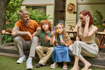Quality moments of a family enjoying bubbles during camping adventures in nature
