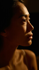 Portrait of woman in warm light showing emotional depth and serenity. Concept of self-reflection, emotional awareness, and personal calmness linked with inner wellness.