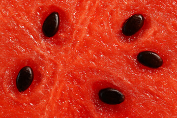 Closeup of a watermelon flesh with seeds creating an abstract pattern