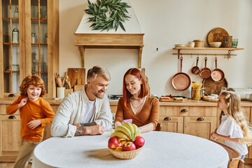 Parents and children laughing together while enjoying family time in their cozy kitchen