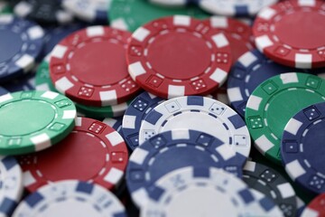 Close up of a group of casino chips on a green mat for poker or dice games indoors