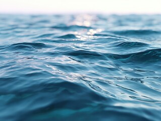 Abstract close-up blue water surface, gentle waves, subtle sun reflections. Tranquil, serene natural liquid background, peaceful texture, minimal movement.