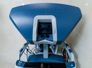 Close up of robotic surgery console station. Close up of surgeon console used for robotic surgery with modern control interface and display.