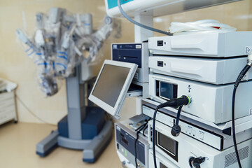 Surgical control equipment and robotic system in hospital. Detailed view of surgical control equipment and robotic surgery system in modern hospital room.