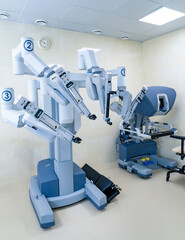 Robotic surgical system in modern hospital. Advanced robotic surgery technology with multiple articulated arms in clean operating room