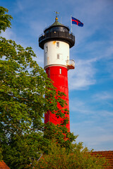 The old lighthouse with its red and white façade on the North Sea island of Wangerooge is a landmark visible from afar, a tourist attraction, and a public monument in the Wadden Sea National Park.