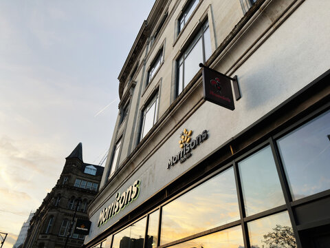 Morrisons sign on a building in Manchester city center, exterior view at sunset