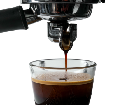 Dark, rich espresso dripping into a clear glass, close up