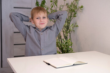 Sad tired boy who doesn't want to learn. Has difficulties with school education, problems with learning skills. Student is upset and depressed. Сoncept of education.