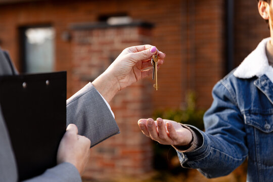 Realtor handing over new house keys to client