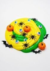 Obraz premium Vibrant yellow and green slime decorated with spooky Halloween items