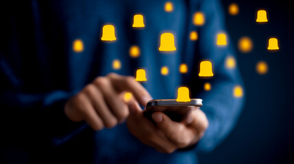 A person holding a smartphone with yellow bell and message icons floating above it